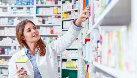 Female pharmacist working late at a 24 hour pharmacy